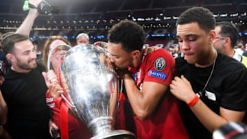 MADRID, SPAIN - JUNE 01: Trent Alexander-Arnold of Liverpool celebrates with the European Cup and members of his family during the UEFA Champions League Final between Tottenham Hotspur and Liverpool at Estadio Wanda Metropolitano on June 01, 2019 in Madrid, Spain. (Photo by Michael Regan/Getty Images)