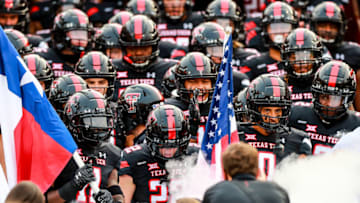 LUBBOCK, TEXAS - SEPTEMBER 12: Defensive back Eric Monroe #11, receiver Sterling Galban #22, and receiver Seth Collins #0 of the Texas Tech Red Raiders lead their teammates onto the field before the college football game against the Houston Baptist Huskies on September 12, 2020 at Jones AT&T Stadium in Lubbock, Texas. (Photo by John E. Moore III/Getty Images)