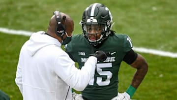 Michigan State's head coach Mel Tucker, left, talks with Angelo Grose during the first quarter in the game against Ohio State on Saturday, Dec. 5, 2020, at Spartan Stadium in East Lansing.Syndication Lansing State Journal