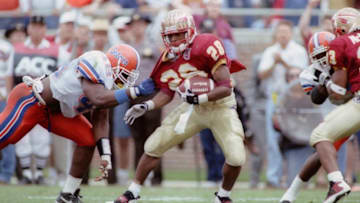 26 NOV 1994: WARRICK DUNN OF FLORIDA STATE, LEFT, IS GRABBED BY DEXTER DANIELS DURING THE FOURTH QUARTER OF THEIR GAME IN TALLAHASSEE, FLORIDA. THE PLAY WAS ON THE THIRD SCORING DRIVE OF THE FOURTH QUARTER AS FLORIDA STATE RALLIED FROM A 31-3 DEFICIT