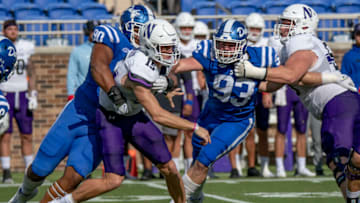 Sep 18, 2021; Durham, North Carolina, USA; Northwestern Wildcats quarterback Hunter Johnson (15) is hit after the release by Duke Blue Devils defensive tackle DeWayne Carter (90) during the first quarter at Wallace Wade Stadium. Mandatory Credit: William Howard-USA TODAY Sports