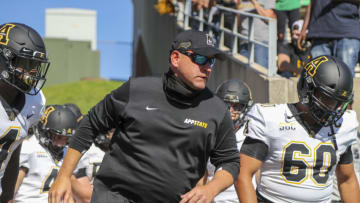 Sep 19, 2020; Huntington, West Virginia, USA; Appalachian State Mountaineers head coach Shawn Clark leads his team onto the field before their game against the Marshall Thundering Herd at Joan C. Edwards Stadium. Mandatory Credit: Ben Queen-USA TODAY Sports