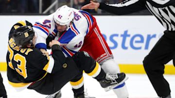 BOSTON, MASSACHUSETTS - NOVEMBER 29: Charlie McAvoy #73 of the Boston Bruins fights with Brendan Smith #42 of the New York Rangers during the second period at TD Garden on November 29, 2019 in Boston, Massachusetts. (Photo by Maddie Meyer/Getty Images)