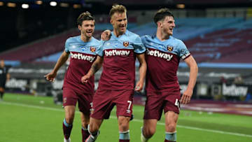West Ham United's English defender Aaron Cresswell (L) and West Ham United's English midfielder Declan Rice (R) congratulate West Ham United's Ukrainian striker Andriy Yarmolenko on scoring their thrid goal during the English Premier League football match between West Ham United and Chelsea at The London Stadium, in east London on July 1, 2020. (Photo by Michael Regan / POOL / AFP) / RESTRICTED TO EDITORIAL USE. No use with unauthorized audio, video, data, fixture lists, club/league logos or 'live' services. Online in-match use limited to 120 images. An additional 40 images may be used in extra time. No video emulation. Social media in-match use limited to 120 images. An additional 40 images may be used in extra time. No use in betting publications, games or single club/league/player publications. / (Photo by MICHAEL REGAN/POOL/AFP via Getty Images)