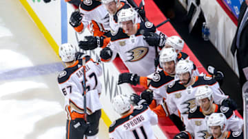 WINNIPEG, MB - JANUARY 13: Rickard Rakell #67 and Daniel Sprong #11 of the Anaheim Ducks celebrate a first period goal against the Winnipeg Jets with teammates at the bench at the Bell MTS Place on January 13, 2019 in Winnipeg, Manitoba, Canada. (Photo by Jonathan Kozub/NHLI via Getty Images)