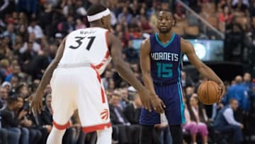 Apr 5, 2016; Toronto, Ontario, CAN; Charlotte Hornets guard Kemba Walker (15) looks to play a ball as Toronto Raptors forward Terrence Ross (31) tries to defend during the second quarter in a game at Air Canada Centre. The Toronto Raptors won 96-90. Mandatory Credit: Nick Turchiaro-USA TODAY Sports