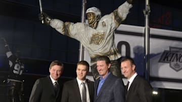 Mar 7, 2015; Los Angeles, CA, USA; Los Angeles Kings former player Luc Robitaille (second from left) poses with Wayne Gretzky (left) , Mario Lemieux (second from right) and Rob Blake at ceremony to unveil statue of Robitaille before the game against the Pittsburgh Penguins at Staples Center. Mandatory Credit: Kirby Lee-USA TODAY Sports