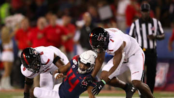 TUCSON, ARIZONA - SEPTEMBER 14: Quarterback Khalil Tate #14 of the Arizona Wildcats fumbles the football as linebackers Riko Jeffers #6 and Jordyn Brooks #1 of the Texas Tech Red Raiders recover during the first half of the NCAAF game at Arizona Stadium on September 14, 2019 in Tucson, Arizona. (Photo by Christian Petersen/Getty Images)