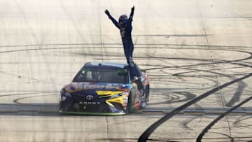 DOVER, DE - OCTOBER 01: Kyle Busch, driver of the #18 M&M's Caramel Toyota, celebrates winning the Monster Energy NASCAR Cup Series Apache Warrior 400 presented by Lucas Oil at Dover International Speedway on October 1, 2017 in Dover, Delaware. (Photo by Brian Lawdermilk/Getty Images)