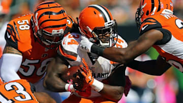 Oct 23, 2016; Cincinnati, OH, USA; Cleveland Browns running back Isaiah Crowell (34) is tackled by Cincinnati Bengals middle linebacker Rey Maualuga (58) and strong safety Shawn Williams (36) in the first half at Paul Brown Stadium. The Bengals won 31-17. Mandatory Credit: Aaron Doster-USA TODAY Sports