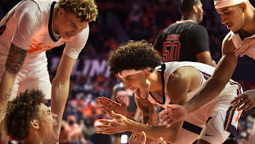 Nov 12, 2021; Champaign, Illinois, USA; Illinois Fighting Illini guard Andre Curbelo (5) gives teammate Benjamin Bosmans-Verdonk (13) a hand after he was fouled against the Arkansas State Red Wolvesat State Farm Center. Mandatory Credit: Ron Johnson-USA TODAY Sports