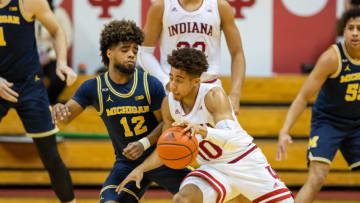 Feb 27, 2021; Bloomington, Indiana, USA; Indiana Hoosiers guard Rob Phinisee (10) dribbles the ball while Michigan Wolverines guard Mike Smith (12) defends in the second half at Simon Skjodt Assembly Hall. Mandatory Credit: Trevor Ruszkowski-USA TODAY Sports