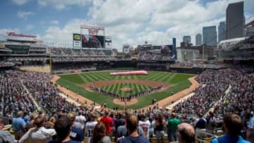 Jul 6, 2014; Minneapolis, MN, USA; Players from the New York Yankees and the Minnesota Twins line up along the base paths for the anthem before the game on Military Appreciation Day at Target Field. The Yankees win 9-7. Mandatory Credit: Bruce Kluckhohn-USA TODAY Sports