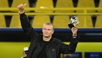 Erling Haaland celebrates on the pitch after receiving the Forward of the Year award (Photo by INA FASSBENDER/AFP via Getty Images)