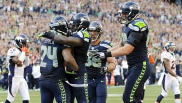 Sep 21, 2014; Seattle, WA, USA; Seattle Seahawks running back Marshawn Lynch (24) and Seattle Seahawks fullback Derrick Coleman (40) celebrate after Lynch scored the game winning touchdown against the Denver Broncos in overtime at CenturyLink Field. Seattle defeated Denver 26-20. Mandatory Credit: Steven Bisig-USA TODAY Sports