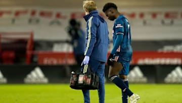 Arsenal's English striker Bukayo Saka (R) leaves the pitch after picking up an injury during the English Premier League football match between Sheffield United and Arsenal at Bramall Lane in Sheffield, northern England on April 11, 2021. - RESTRICTED TO EDITORIAL USE. No use with unauthorized audio, video, data, fixture lists, club/league logos or 'live' services. Online in-match use limited to 120 images. An additional 40 images may be used in extra time. No video emulation. Social media in-match use limited to 120 images. An additional 40 images may be used in extra time. No use in betting publications, games or single club/league/player publications. (Photo by Tim Keeton / POOL / AFP) / RESTRICTED TO EDITORIAL USE. No use with unauthorized audio, video, data, fixture lists, club/league logos or 'live' services. Online in-match use limited to 120 images. An additional 40 images may be used in extra time. No video emulation. Social media in-match use limited to 120 images. An additional 40 images may be used in extra time. No use in betting publications, games or single club/league/player publications. / RESTRICTED TO EDITORIAL USE. No use with unauthorized audio, video, data, fixture lists, club/league logos or 'live' services. Online in-match use limited to 120 images. An additional 40 images may be used in extra time. No video emulation. Social media in-match use limited to 120 images. An additional 40 images may be used in extra time. No use in betting publications, games or single club/league/player publications. (Photo by TIM KEETON/POOL/AFP via Getty Images)
