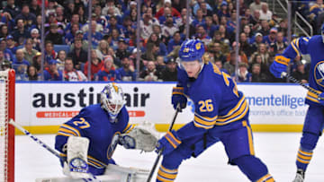 Mar 31, 2023; Buffalo, New York, USA; Buffalo Sabres defenseman Rasmus Dahlin (26) deflects a shot btthe New York Rangers to help goaltender Devon Levi (27) in the third period at KeyBank Center. Mandatory Credit: Mark Konezny-USA TODAY Sports