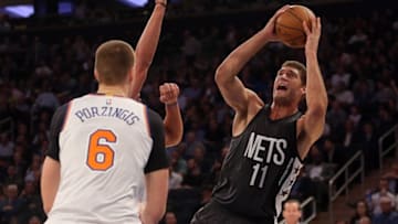 Nov 9, 2016; New York, NY, USA; Brooklyn Nets center Brook Lopez (11) shoots against New York Knicks center Joakim Noah (13) and New York Knicks power forward Kristaps Porzingis (6) during the second quarter at Madison Square Garden. Mandatory Credit: Brad Penner-USA TODAY Sports