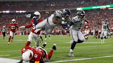 GLENDALE, AZ - SEPTEMBER 30: Running back Mike Davis #27 of the Seattle Seahawks scores a 20-yard touchdown over defensive back Antoine Bethea #41 of the Arizona Cardinals during the first quarter at State Farm Stadium on September 30, 2018 in Glendale, Arizona. (Photo by Ralph Freso/Getty Images)