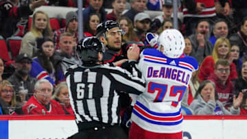 Feb 21, 2020; Raleigh, North Carolina, USA; Carolina Hurricanes right wing Nino Niederreiter (21) and New York Rangers defenseman Tony DeAngelo (77) battle in the third period at PNC Arena. The New York Rangers defeated the Carolina Hurricanes 5-2. Mandatory Credit: James Guillory-USA TODAY Sports