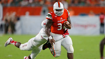 MIAMI GARDENS, FL - SEPTEMBER 10: Marquez Williams #36 of the Miami Hurricanes is tackled by Rashad Smith #7 of the Florida Atlantic Owls as he runs with the ball on September 10, 2016 at Hard Rock Stadium in Miami Gardens, Florida.Miami defeated Florida Atlantic 38-10. (Photo by Joel Auerbach/Getty Images)