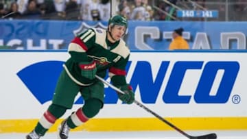 Feb 21, 2016; Minneapolis, MN, USA; Minnesota Wild forward Zach Parise (11) carries the puck in the third period during a Stadium Series hockey game against the Chicago Blackhawks at TCF Bank Stadium. The Wild defeated the Blackhawks 6-1. Mandatory Credit: Brace Hemmelgarn-USA TODAY Sports