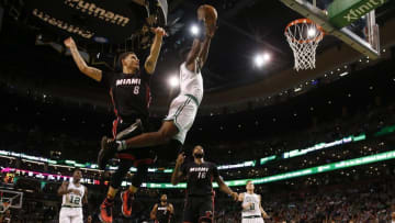 Dec 30, 2016; Boston, MA, USA; Boston Celtics forward Jaylen Brown (7) soars past Miami Heat guard Tyler Johnson (8) for a dunk during the second half at TD Garden. Mandatory Credit: Winslow Townson-USA TODAY Sports