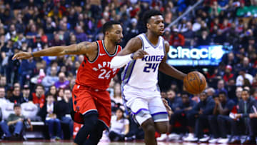 TORONTO, ON - December 17: Buddy Hield #24 of the Sacramento Kings dribbles the ball as Norman Powell #24 of the Toronto Raptors defends during the first half of an NBA game at Air Canada Centre on December 17, 2017 in Toronto, Canada. NOTE TO USER: User expressly acknowledges and agrees that, by downloading and or using this photograph, User is consenting to the terms and conditions of the Getty Images License Agreement. (Photo by Vaughn Ridley/Getty Images)