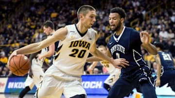 Feb 3, 2016; Iowa City, IA, USA; Iowa Hawkeyes forward Jarrod Uthoff (20) controls the ball as Penn State Nittany Lions forward Payton Banks (0) defends during the second half at Carver-Hawkeye Arena. Iowa won 73-49. Mandatory Credit: Jeffrey Becker-USA TODAY Sports