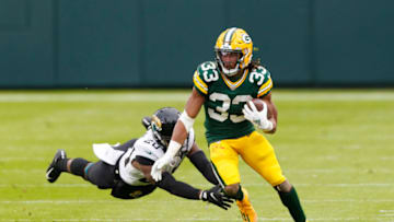 Nov 15, 2020; Green Bay, Wisconsin, USA; Green Bay Packers running back Aaron Jones (33) runs the football against Jacksonville Jaguars safety Daniel Thomas (20) during the fourth quarter at Lambeau Field. Mandatory Credit: Jeff Hanisch-USA TODAY Sports