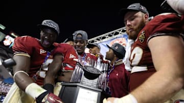 CHARLOTTE, NC - DECEMBER 01: Teammates Karlos Williams #9 of the Florida State Seminoles and James Wilder Jr. #32 celebrate with the trophy after defeating the Georgia Tech Yellow Jackets 21-15 in the 2012 ACC Championship game at Bank of America Stadium on December 1, 2012 in Charlotte, North Carolina. (Photo by Streeter Lecka/Getty Images)