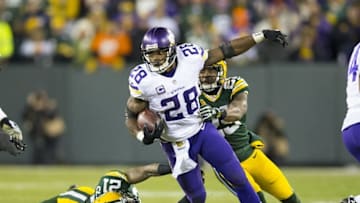 Jan 3, 2016; Green Bay, WI, USA; Minnesota Vikings running back Adrian Peterson (28) rushes with the football during the third quarter against the Green Bay Packers at Lambeau Field. Minnesota won 20-13. Mandatory Credit: Jeff Hanisch-USA TODAY Sports