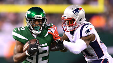 EAST RUTHERFORD, NEW JERSEY - OCTOBER 21: Jamison Crowder #82 of the New York Jets is hit by Jonathan Jones #31 of the New England Patriots as he carries the ball during the second half of their game at MetLife Stadium on October 21, 2019 in East Rutherford, New Jersey. (Photo by Emilee Chinn/Getty Images)