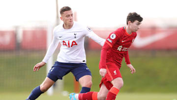 KIRKBY, ENGLAND - MARCH 12: Mateusz Musialowski of Liverpool battles for possession with Charlie Sayers of Tottenham Hotspur during the Premier League 2 match between Liverpool and Tottenham Hotspur at AXA Training Centre on March 12, 2022 in Kirkby, England. (Photo by Lewis Storey/Getty Images)