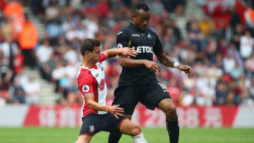 SOUTHAMPTON, ENGLAND - AUGUST 12: Cedric Soares of Southampton tackles Jordan Ayew of Swansea City during the Premier League match between Southampton and Swansea City at St Mary's Stadium on August 12, 2017 in Southampton, England. (Photo by Charlie Crowhurst/Getty Images)