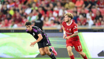 SINGAPORE, SINGAPORE - AUGUST 2: Harvey Elliott of Liverpool FC (R) controls the ball under pressure of FC Bayern Munchen player during the pre-season friendly match between Liverpool and Bayern Muenchen at the National Stadium on August 2, 2023 in Singapore. (Photo by Apinya Rittipo/Getty Images)
