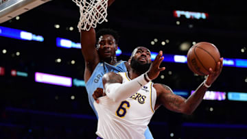 Jan 9, 2022; Los Angeles, California, USA; Los Angeles Lakers forward LeBron James (6) scores a basket and draws the foul against Memphis Grizzlies forward Jaren Jackson Jr. (13) during the first half at Crypto.com Arena. Mandatory Credit: Gary A. Vasquez-USA TODAY Sports