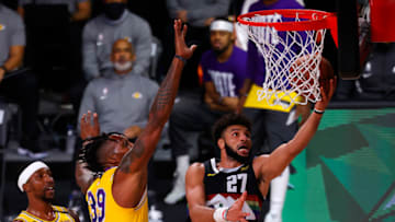 LAKE BUENA VISTA, FLORIDA - SEPTEMBER 24: Jamal Murray #27 of the Denver Nuggets drives to the ball against Dwight Howard #39 of the Los Angeles Lakers during the third quarter in Game Four of the Western Conference Finals during the 2020 NBA Playoffs at AdventHealth Arena at the ESPN Wide World Of Sports Complex on September 24, 2020 in Lake Buena Vista, Florida. NOTE TO USER: User expressly acknowledges and agrees that, by downloading and or using this photograph, User is consenting to the terms and conditions of the Getty Images License Agreement. (Photo by Mike Ehrmann/Getty Images)