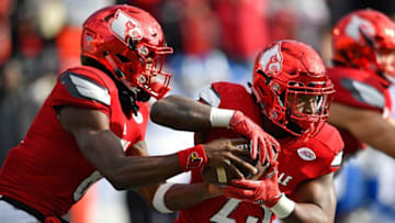 Nov 26, 2016; Louisville, KY, USA; Louisville Cardinals quarterback Lamar Jackson (8) fakes a hand off to running back Brandon Radcliff (23) during the second half against the Kentucky Wildcats at Papa John