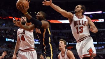 Mar 18, 2015; Chicago, IL, USA; Indiana Pacers guard C.J. Miles (center) is defended by Chicago Bulls center Joakim Noah (13) and forward Nikola Mirotic (44) during the second half at the United Center. The Chicago Bulls defeated the Indiana Pacers 103-86. Mandatory Credit: David Banks-USA TODAY Sports