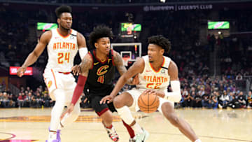 CLEVELAND, OHIO - FEBRUARY 12: Bruno Fernando #24 sets a pick as Cam Reddish #22 of the Atlanta Hawks drives around Kevin Porter Jr. #4 of the Cleveland Cavaliers during the first half at Rocket Mortgage Fieldhouse on February 12, 2020 in Cleveland, Ohio. NOTE TO USER: User expressly acknowledges and agrees that, by downloading and/or using this photograph, user is consenting to the terms and conditions of the Getty Images License Agreement. (Photo by Jason Miller/Getty Images)