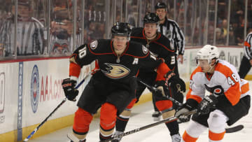 ANAHEIM, CA - DECEMBER 31: Corey Perry #10 of the Anaheim Ducks drives the puck against Danny Briere #48 of the Philadelphia Flyers during the game on December 31, 2010 at Honda Center in Anaheim, California. (Photo by Debora Robinson/NHLI via Getty Images)
