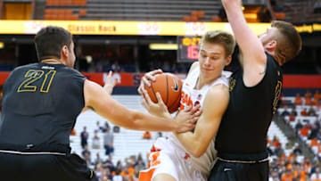 SYRACUSE, NY - OCTOBER 25: Buddy Boeheim #35 of the Syracuse Orange drives to the basket against the defense of Jeff Allen #21 and Shane Herrity #12 of the St. Rose Golden Knights during the first half at the Carrier Dome on October 25, 2018 in Syracuse, New York. (Photo by Rich Barnes/Getty Images)