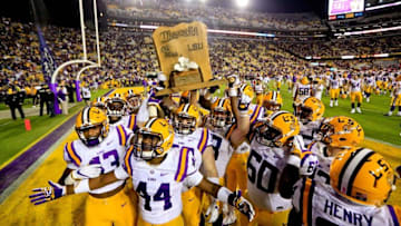 Oct 22, 2016; Baton Rouge, LA, USA; LSU Tigers players celebrate with the Magnolia Bowl trophy following a win against the Mississippi Rebels in a game at Tiger Stadium. LSU defeated Mississippi 38-21. Mandatory Credit: Derick E. Hingle-USA TODAY Sports