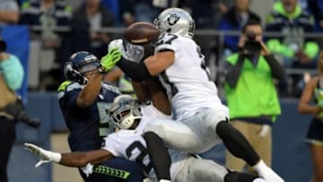 Sep 3, 2015; Seattle, WA, USA; Seattle Seahawks receiver B.J. Daniels (5) is defended by Oakland Raiders cornerback D.J. Hayden (25) and safety Taylor Mays (27) at CenturyLink Field. Mandatory Credit: Kirby Lee-USA TODAY Sports