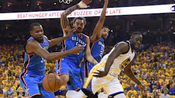 May 18, 2016; Oakland, CA, USA; Golden State Warriors forward Draymond Green (23) passes the basketball against Oklahoma City Thunder forward Kevin Durant (35), center Steven Adams (12), and guard Andre Roberson (21) during the first quarter in game two of the Western conference finals of the NBA Playoffs at Oracle Arena. Mandatory Credit: Kyle Terada-USA TODAY Sports