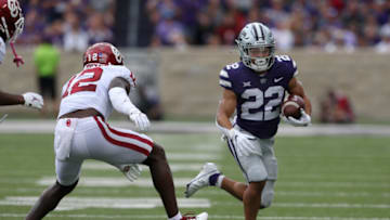 Oct 2, 2021; Manhattan, Kansas, USA; Kansas State Wildcats running back Deuce Vaughn (22) runs against Oklahoma Sooners defensive back Key Lawrence (12) during the first quarter of a game at Bill Snyder Family Football Stadium. Mandatory Credit: Scott Sewell-USA TODAY Sports