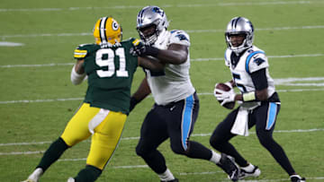 GREEN BAY, WISCONSIN - DECEMBER 19: Quarterback Teddy Bridgewater #5 of the Carolina Panthers drops back to pass against the outside linebacker Preston Smith #91 of the Green Bay Packers during the game at Lambeau Field on December 19, 2020 in Green Bay, Wisconsin. (Photo by Dylan Buell/Getty Images)