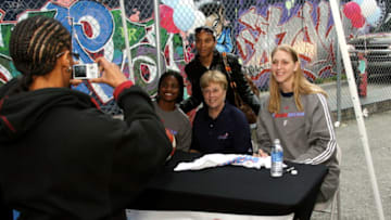 ATLANTA - APRIL 3: Ivory Latta, Head Coach Marynell Meadors, and Katie Feenstra of the Atlanta Dream pose with fans after a press conference unveiling the new uniforms at Centennial Tower on April 3, 2008 in Atlanta, Georgia. NOTE TO USER: User expressly acknowledges and agrees that, by downloading and/or using this Photograph, user is consenting to the terms and conditions of the Getty Images License Agreement. Mandatory Copyright Notice: Copyright 2008 NBAE. (Photo by Scott Cunningham/NBAE via Getty Images)