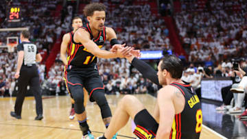 MIAMI, FLORIDA - APRIL 17: Trae Young #11 of the Atlanta Hawks helps Danilo Gallinari #8 off the court against the Miami Heat during the first quarter in Game One of the Eastern Conference First Round at FTX Arena on April 17, 2022 in Miami, Florida. NOTE TO USER: User expressly acknowledges and agrees that, by downloading and or using this photograph, User is consenting to the terms and conditions of the Getty Images License Agreement. (Photo by Michael Reaves/Getty Images)